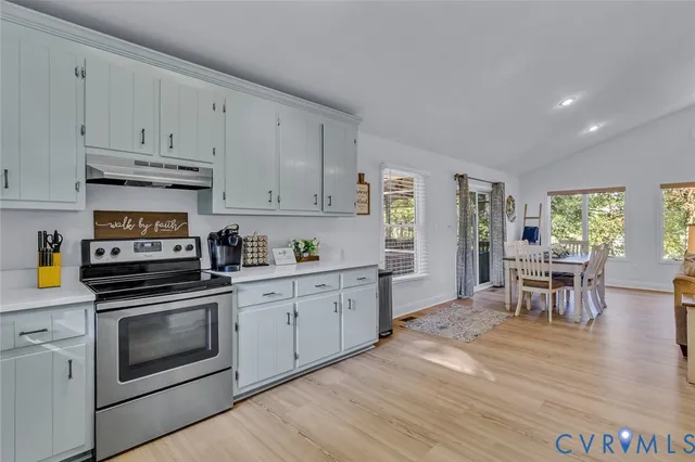 a kitchen with granite countertop white cabinets and white appliances
