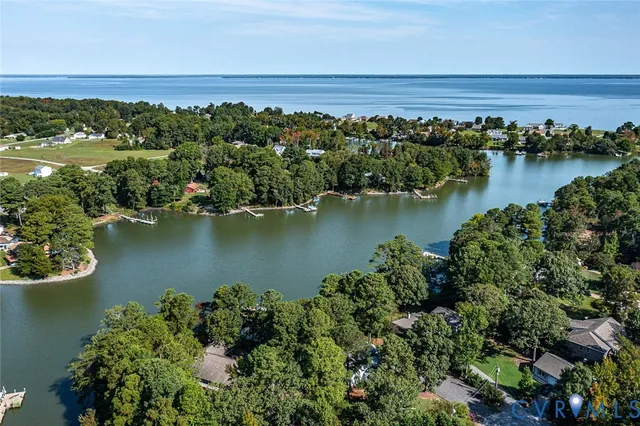 an aerial view of a houses with a lake view