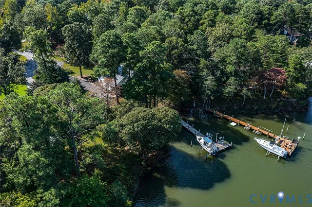 an aerial view of lake residential house with outdoor space and trees around