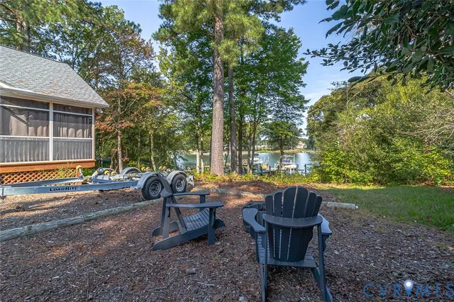 a view of a patio with table and chairs and wooden fence