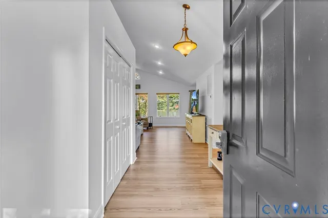 a view of a hallway with wooden floor