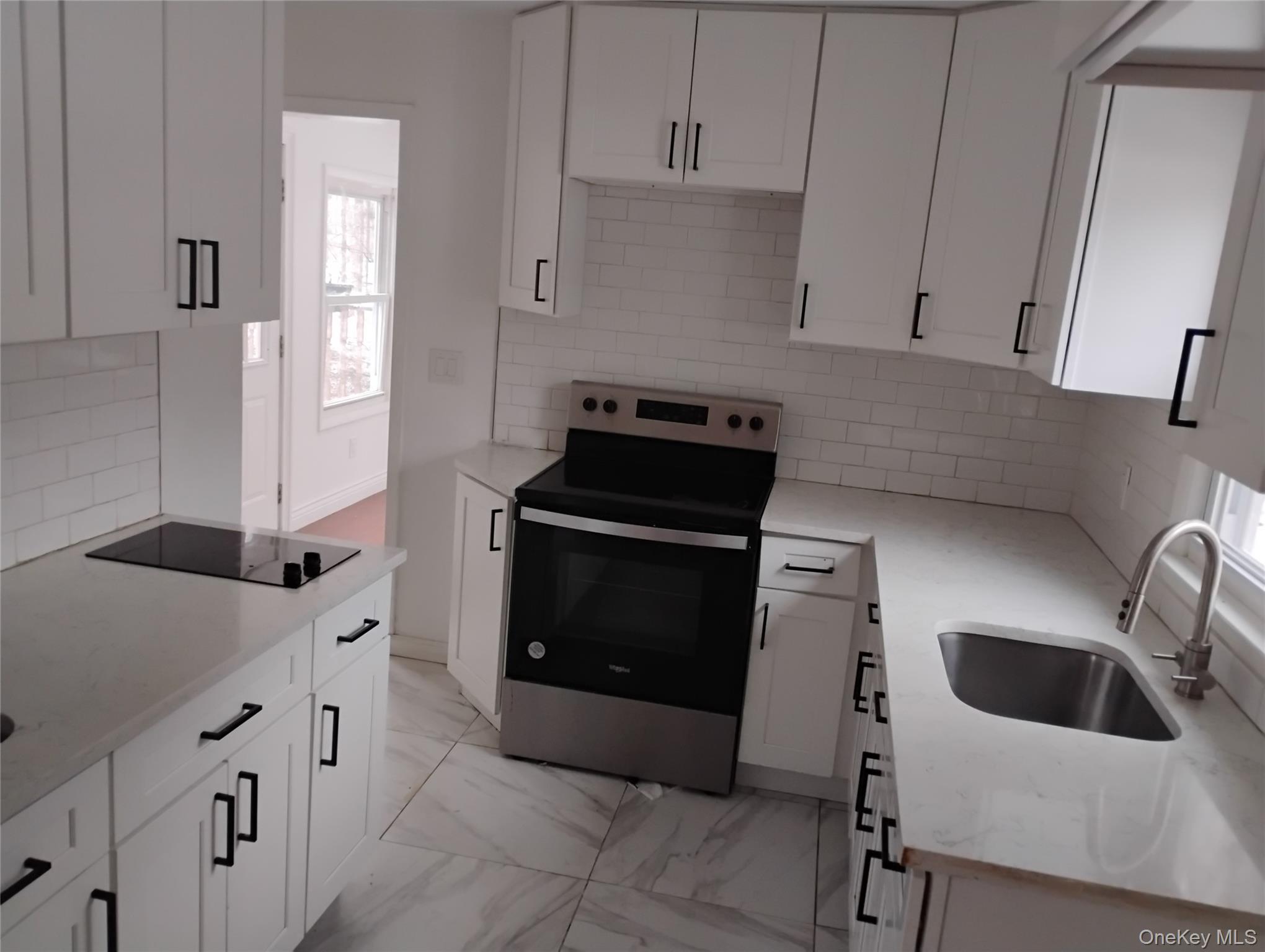 9 Merriewold Lane South Monroe, NY 10950 - Photo 12 of 17 a kitchen with granite countertop white cabinets and white appliances