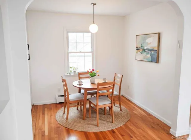 a dining room with furniture and window