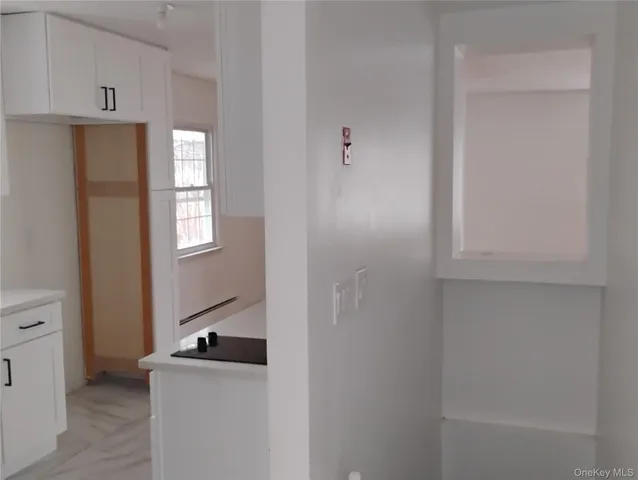 a kitchen with a stove top oven and cabinets