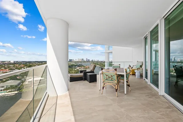 a view of a city from a dining room with furniture