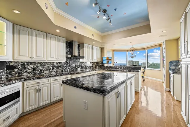 a kitchen with stainless steel appliances granite countertop a sink and cabinets
