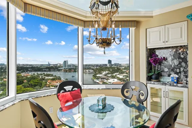 a living room filled with furniture and a floor to ceiling window