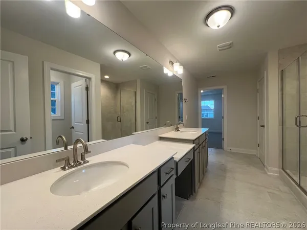 a bathroom with a sink double vanity granite and a mirror