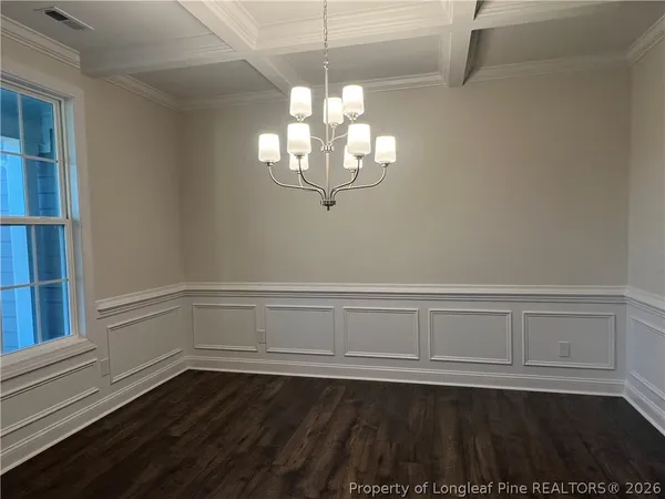 a view of wooden floor and chandelier in a room