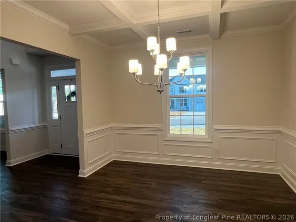a view of a room with wooden floor and windows