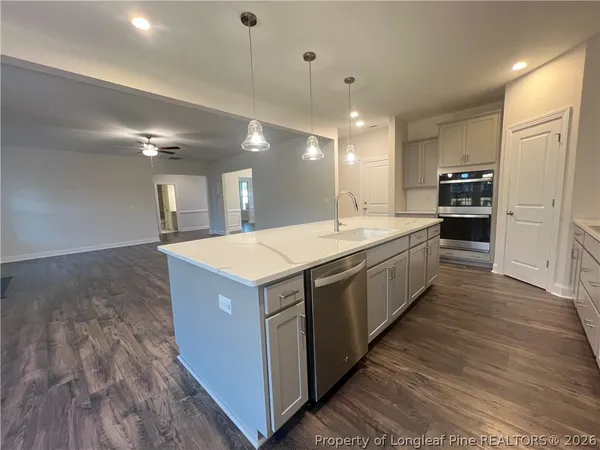 a large kitchen with a large counter top and stainless steel appliances