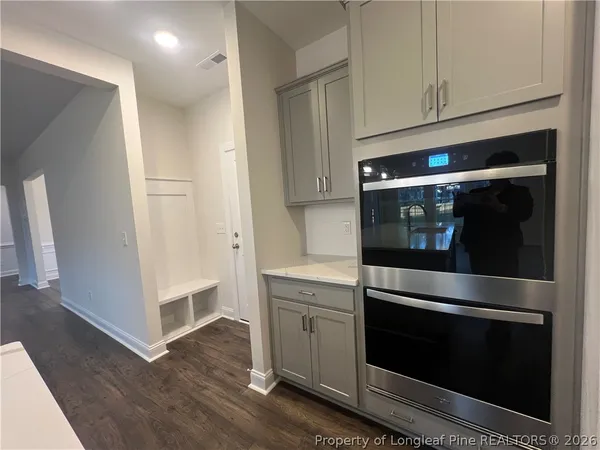 a kitchen with stainless steel appliances white cabinets and a granite counter tops