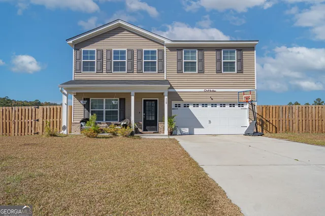 a front view of a house with outdoor seating and a yard