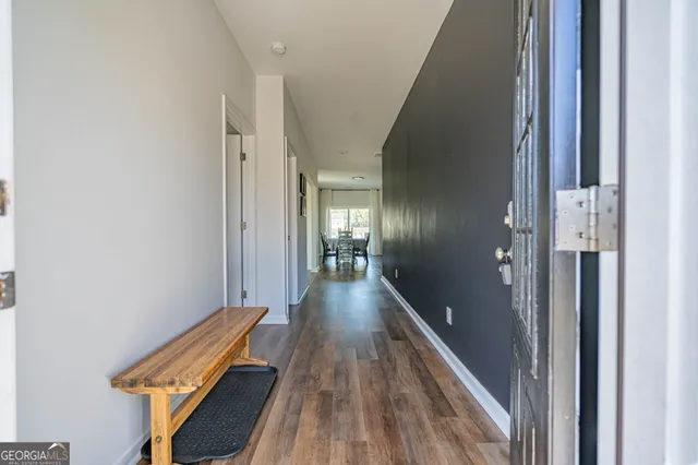 a view of a hallway with wooden floor