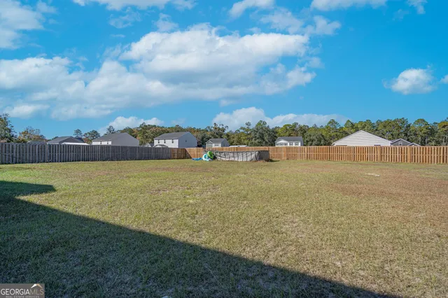 a view of a lake with houses in the back