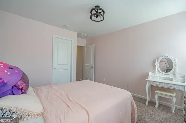 a bedroom with a bed and a chair