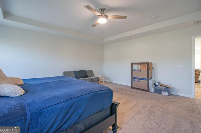 a bathroom with a granite countertop sink a toilet and a mirror