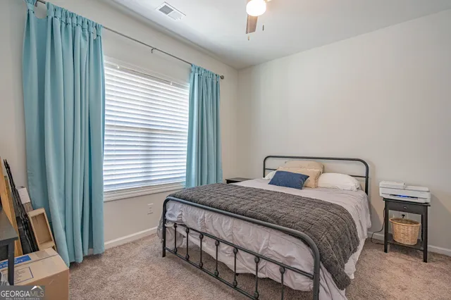 a bedroom with two beds and a lamp on table