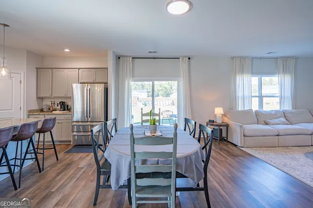 a view of a dining room with furniture window and wooden floor