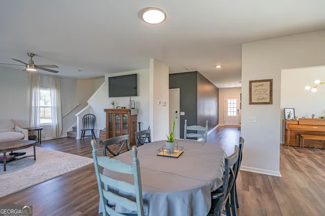 a view of a a dining room with furniture window and wooden floor