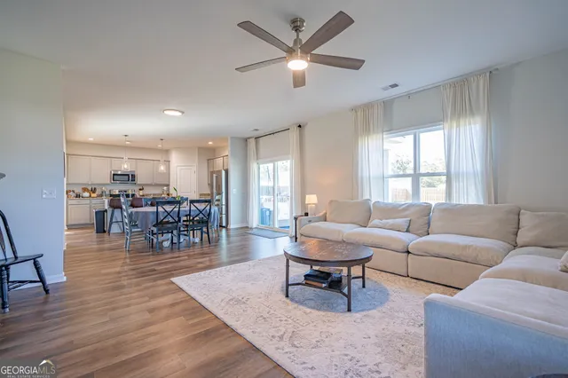 a living room with furniture and wooden floor