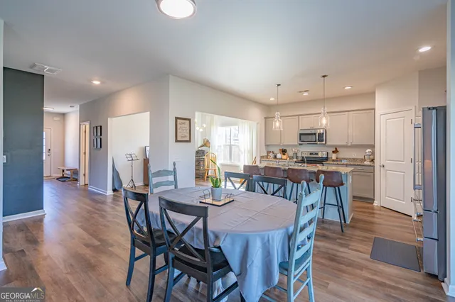 a view of a dining room with furniture and wooden floor