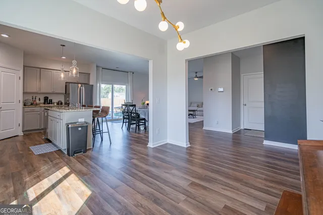 a view of a kitchen with cabinets stainless steel appliances and wooden floor