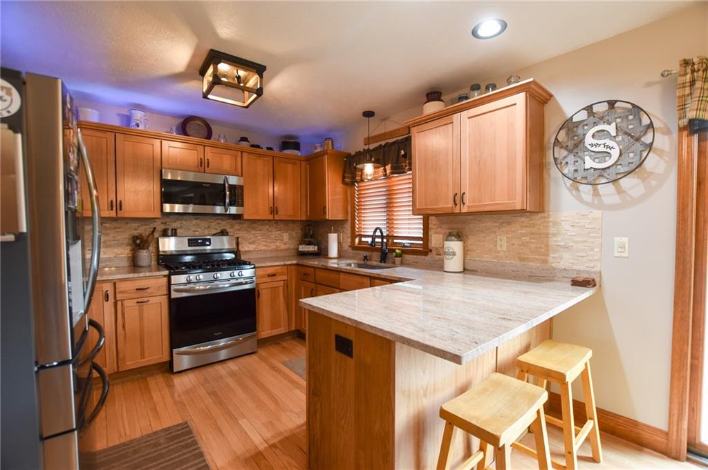 252 Becker Road Butler, PA 16002 - Photo 6 of 23 a kitchen with stainless steel appliances granite countertop a stove refrigerator sink and microwave
