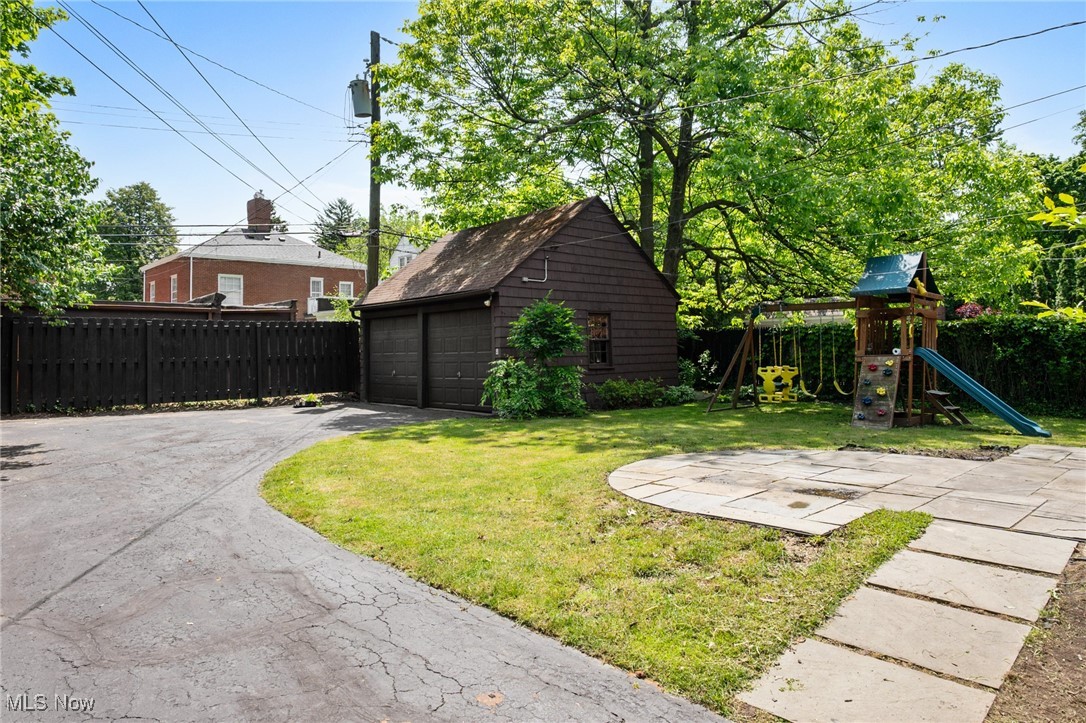 3677 Traver Road Shaker Heights, OH 44122 - Photo 32 of 35 View of yard with a garage, an outdoor structure, and a playground