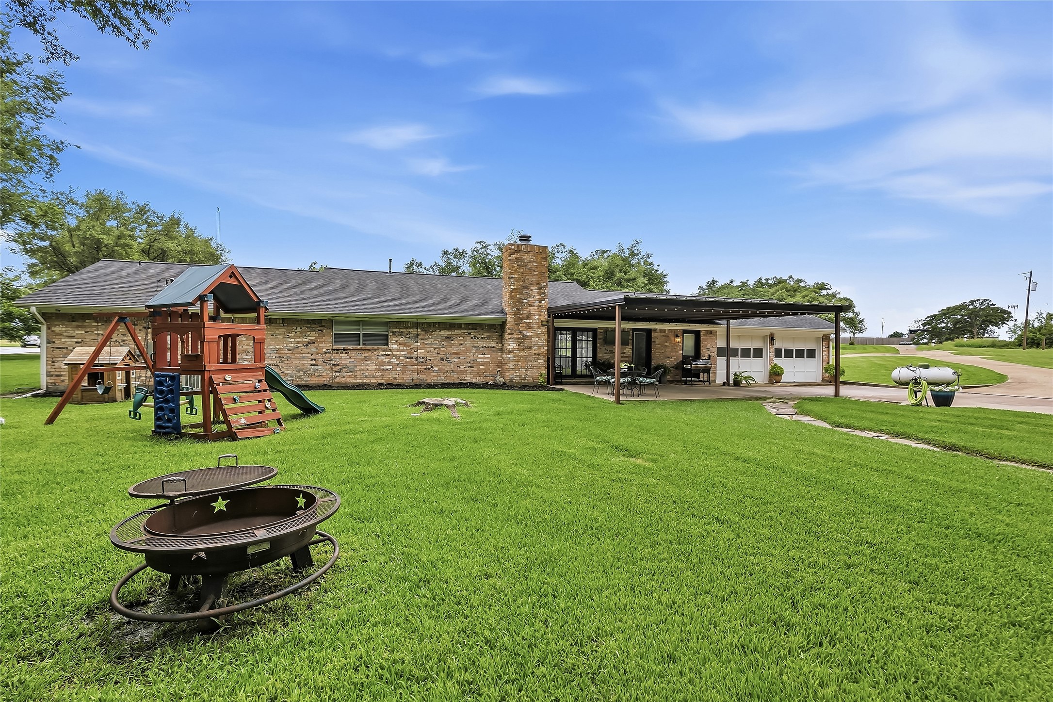 906 Standley Road Madisonville, TX 77864 - Photo 34 of 40 a view of a house with a yard porch and sitting area