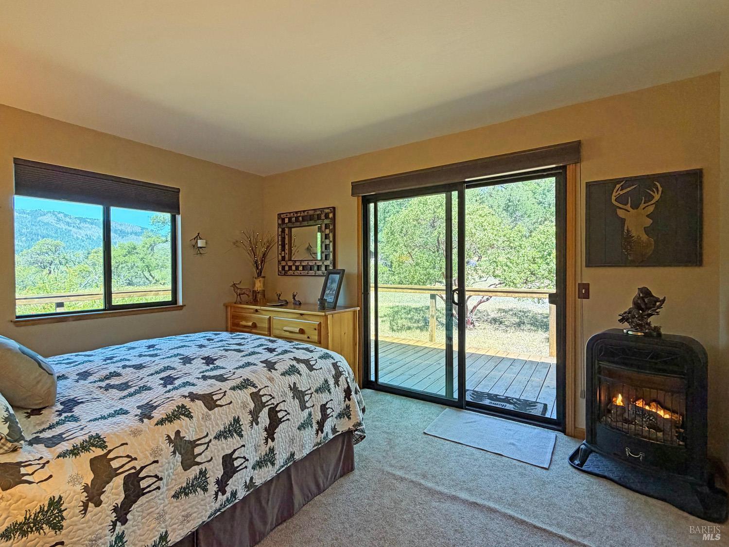 31312 High Point Road Potter Valley, CA 95469 - Photo 23 of 58 a bedroom with a bed and a dresser next to a window