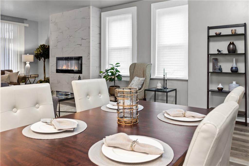 1256 Superior Avenue Pittsburgh, PA 15212 - Photo 17 of 50 a dining room with furniture a large window and wooden floor