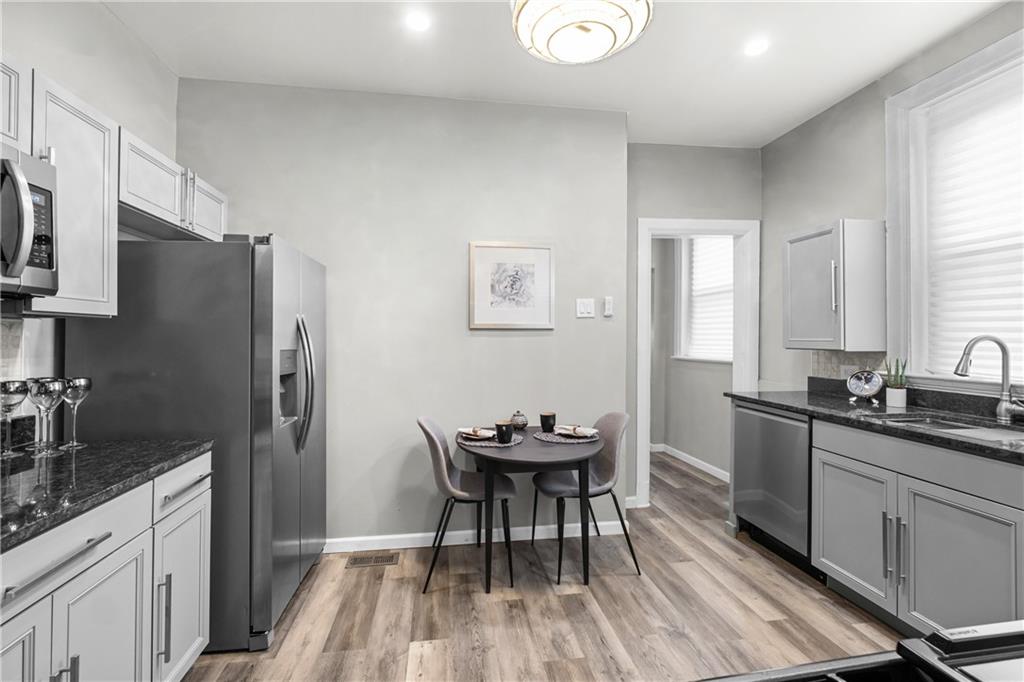 1256 Superior Avenue Pittsburgh, PA 15212 - Photo 31 of 50 a kitchen with granite countertop a sink stove and refrigerator