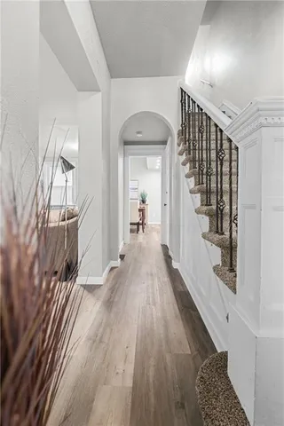 view of a hallway with wooden floor and staircase