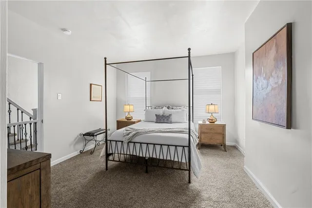 a bedroom with three beds and a chandelier