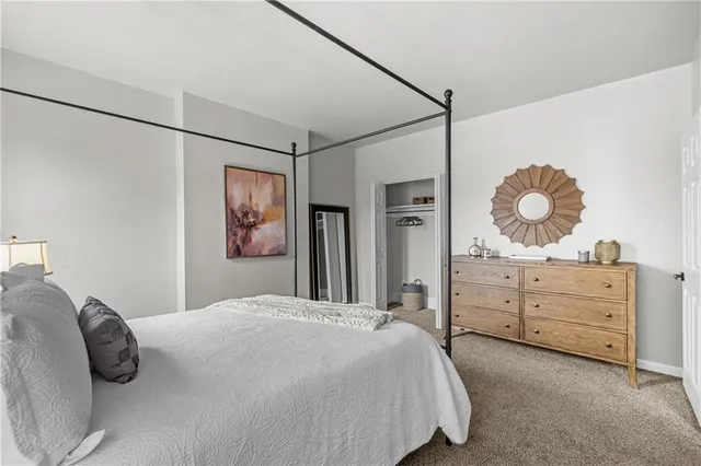 a bedroom with a bed and a mirror