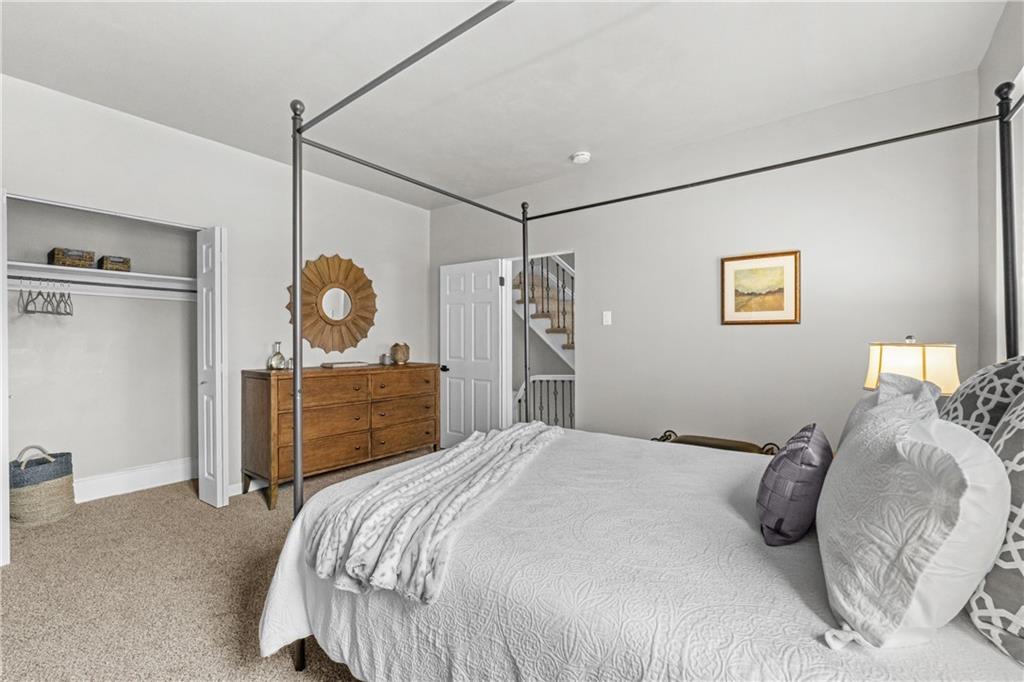 1256 Superior Avenue Pittsburgh, PA 15212 - Photo 39 of 50 a bedroom with a bed and a mirror