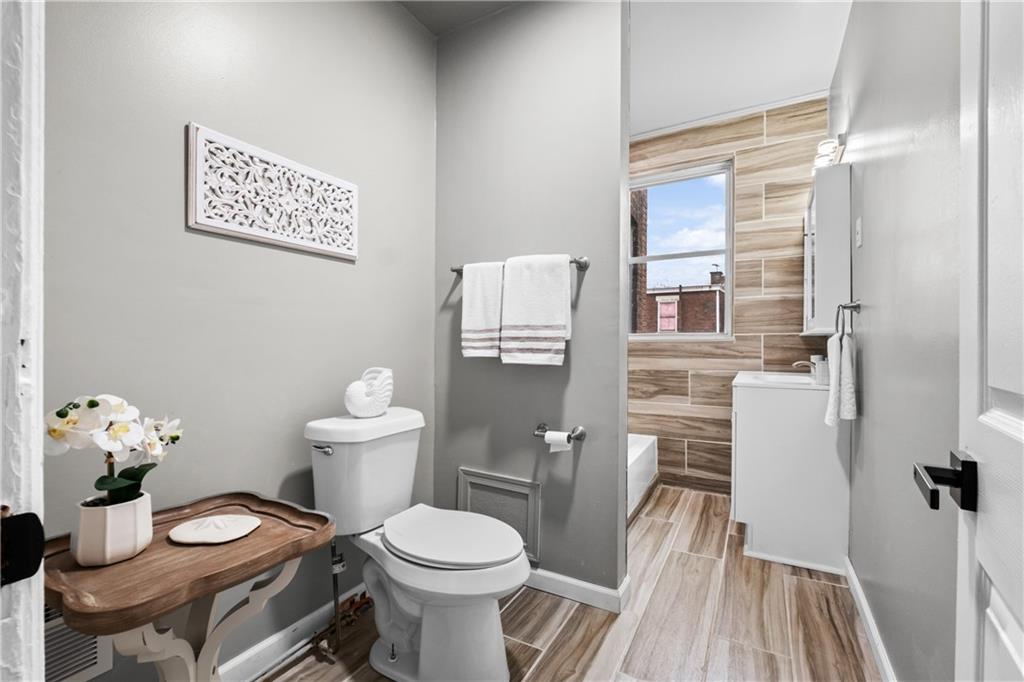 1256 Superior Avenue Pittsburgh, PA 15212 - Photo 42 of 50 a white toilet sitting next to a bathroom sink
