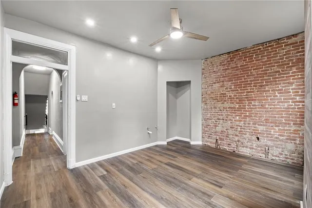 an empty room with windows and closet