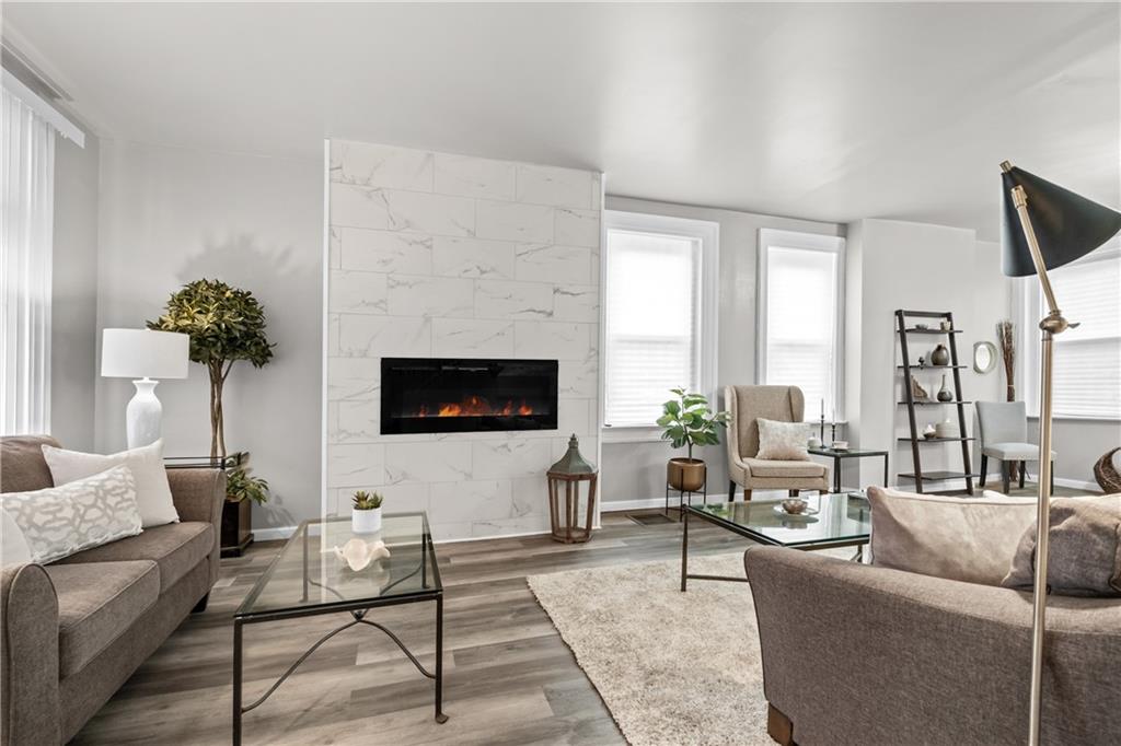 1256 Superior Avenue Pittsburgh, PA 15212 - Photo 6 of 50 a living room with furniture a large window and a flat screen tv