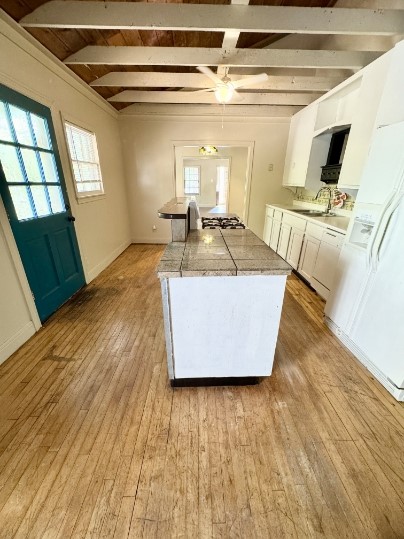 a living room with couches and flat screen tv with wooden floor