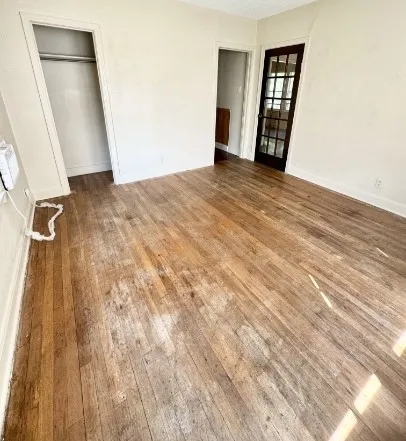 a view of an empty room and wooden floor