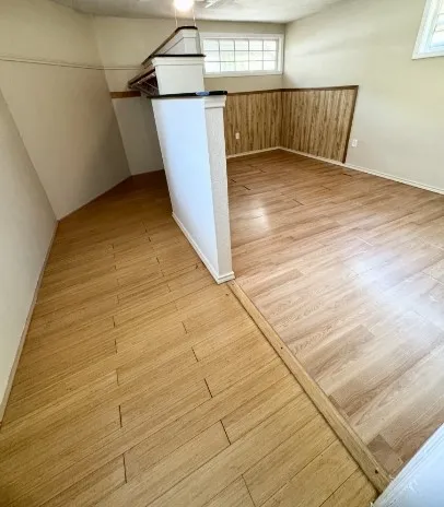 a view of a room with wooden floor