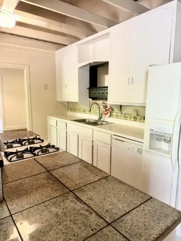 a kitchen with a sink stove and refrigerator