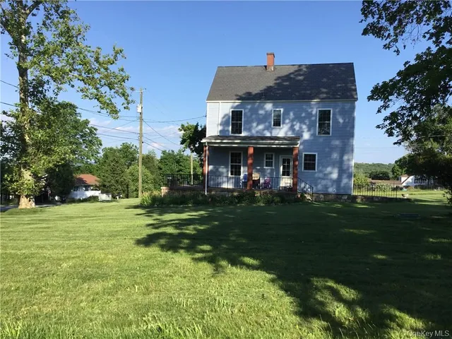 a front view of a house with a yard table and chairs