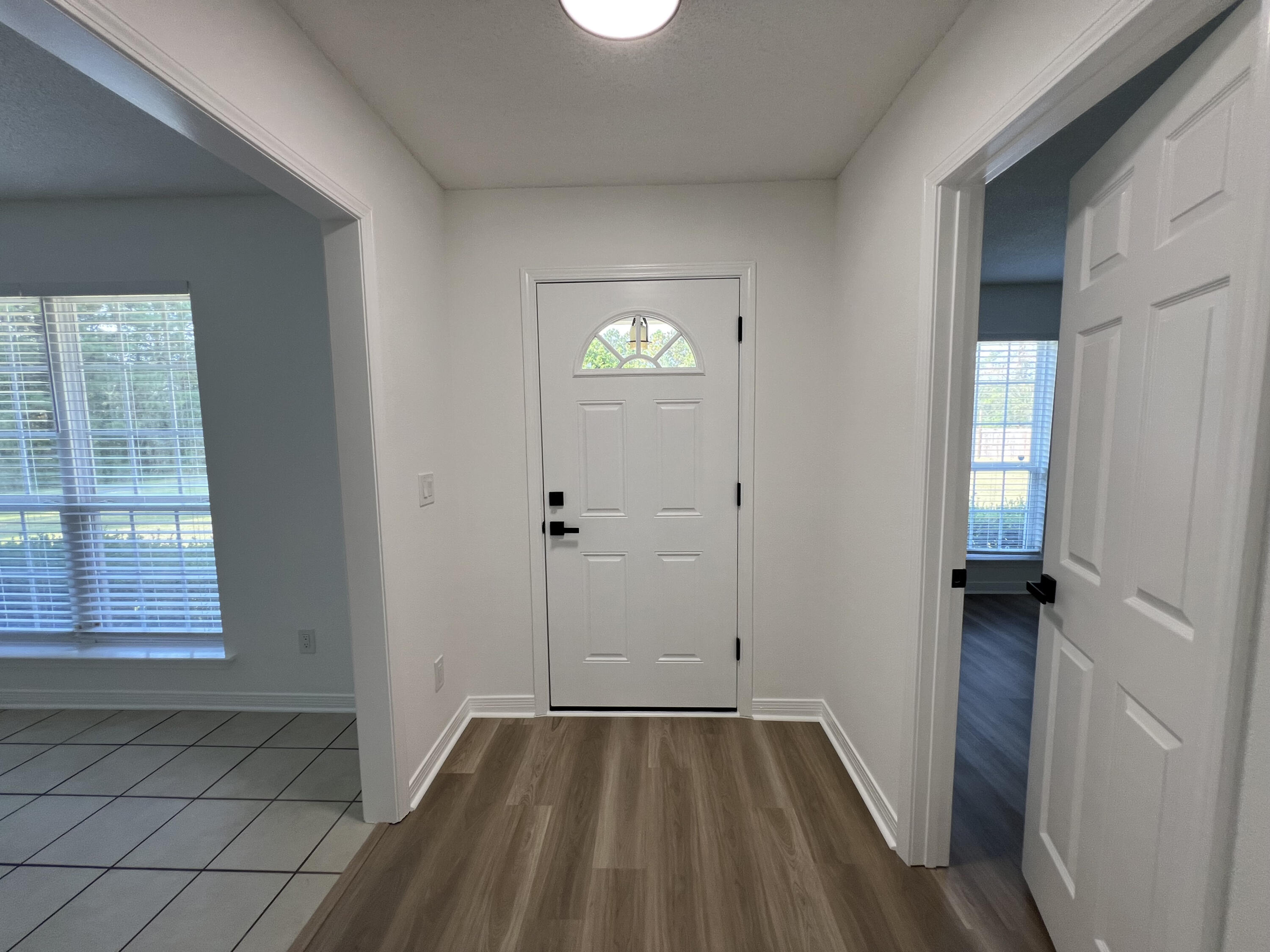 5330 John Lowery Road Jay, FL 32565 - Photo 11 of 30 a view of an empty room with wooden floor and a window