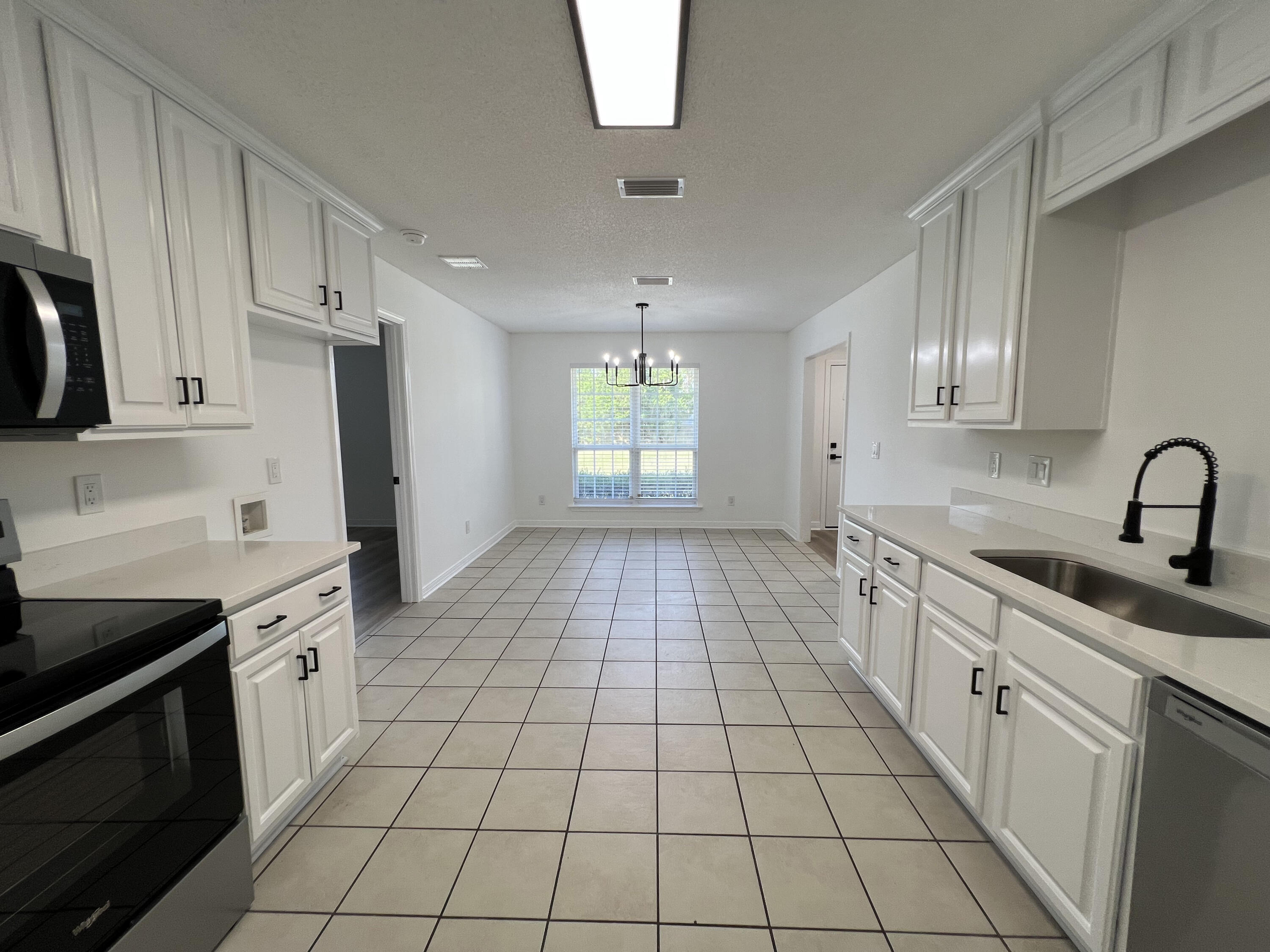 5330 John Lowery Road Jay, FL 32565 - Photo 16 of 30 a kitchen with a sink a stove and cabinets