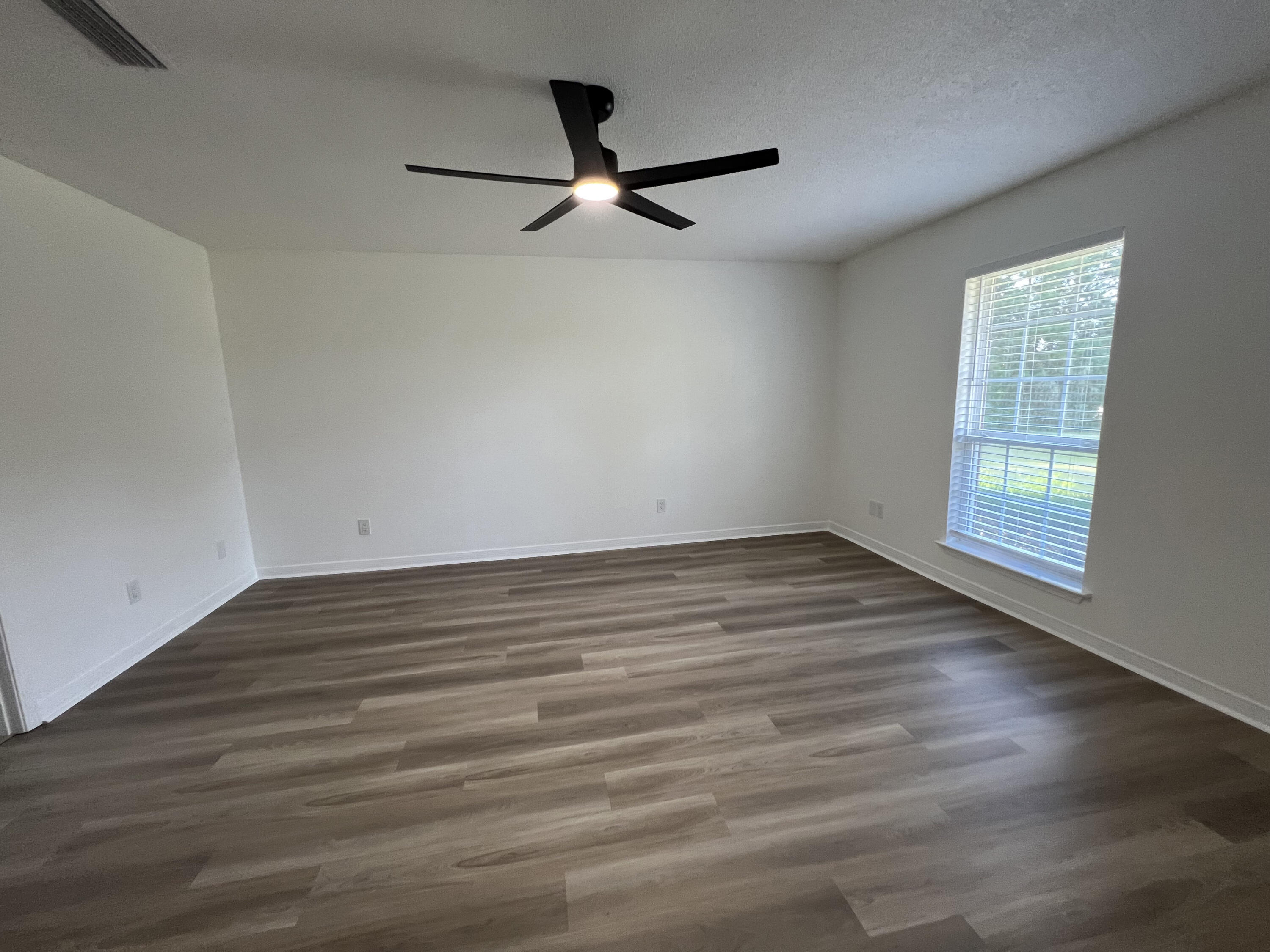 5330 John Lowery Road Jay, FL 32565 - Photo 21 of 30 wooden floor in an empty room with a window