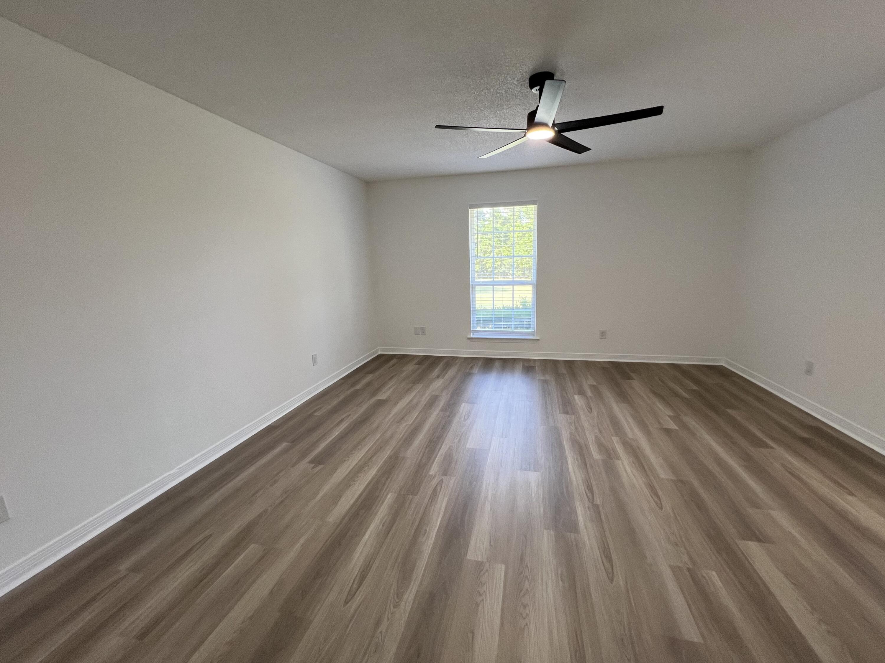 5330 John Lowery Road Jay, FL 32565 - Photo 27 of 30 wooden floor in an empty room with a window
