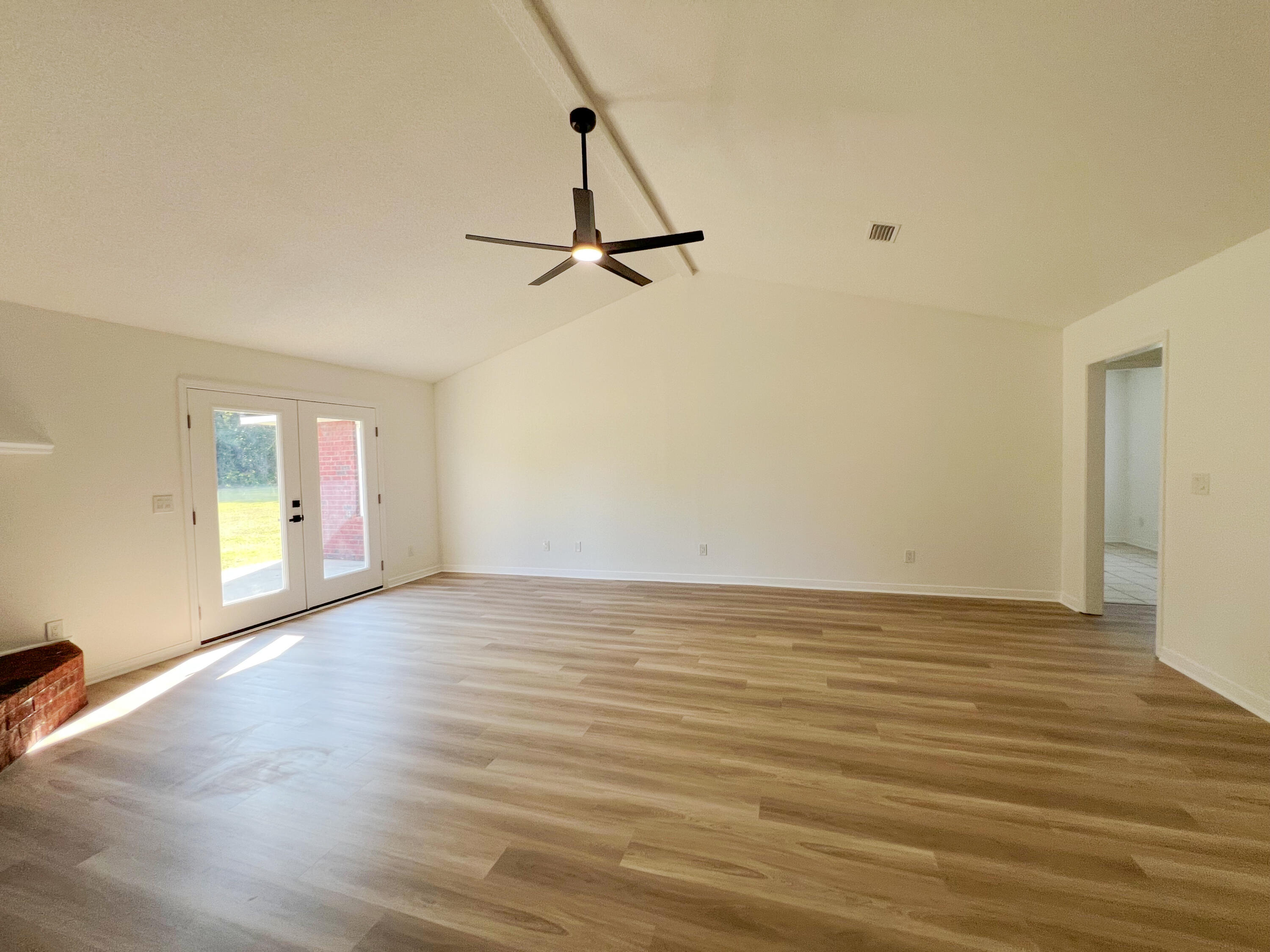 5330 John Lowery Road Jay, FL 32565 - Photo 9 of 30 a view of empty room with wooden floor and fan